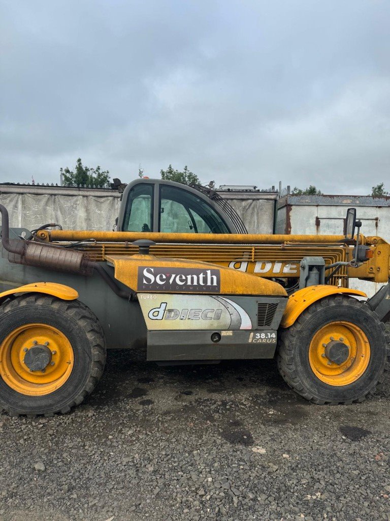 Telehandler halfway through a clean, with the body washed and the boom still dirty